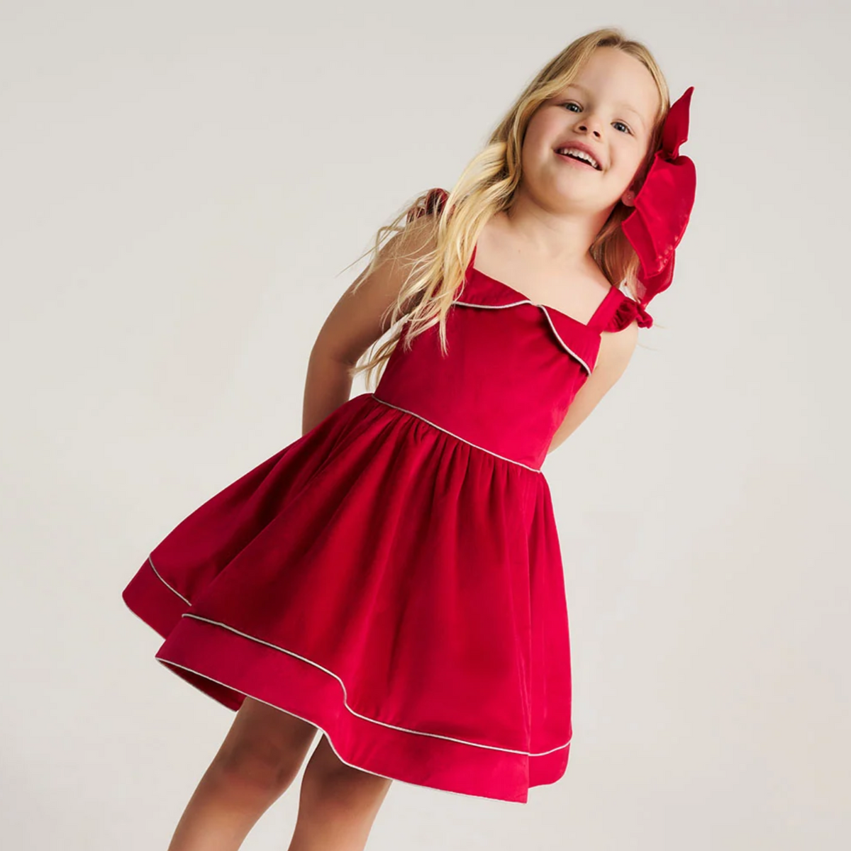 Girl twirling in the Crimson Red Velveteen Petticoat Dress
