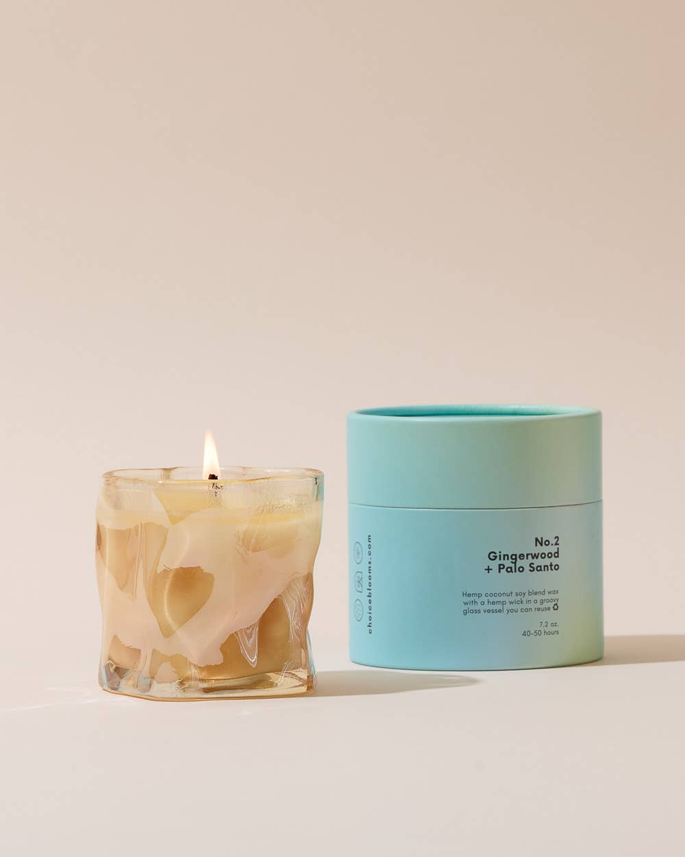 7.2oz Choice Blooms No. 2 Gingerwood and Palo Santo candle with warm, inviting scent in a glass jar.