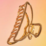 Gold open shape claw clip by KITSCH with sleek, minimalist design, perfect for securing hair in stylish updos.
