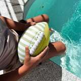 Sunnylife Neoprene Football Tides Out Citrus inflatable pool float featuring vibrant citrus design on a bright outdoor setting