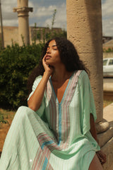 Checkered aqua sequin thobe by pītusa, featuring a traditional long dress design with shimmering sequins and checkered pattern.