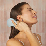 KITSCH detangling brush in haze blue with flexible bristles for gentle, knot-free hair detangling and smooth styling.
