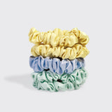 Set of five KITSCH ruched satin scrunchies in various vibrant colors on a white background