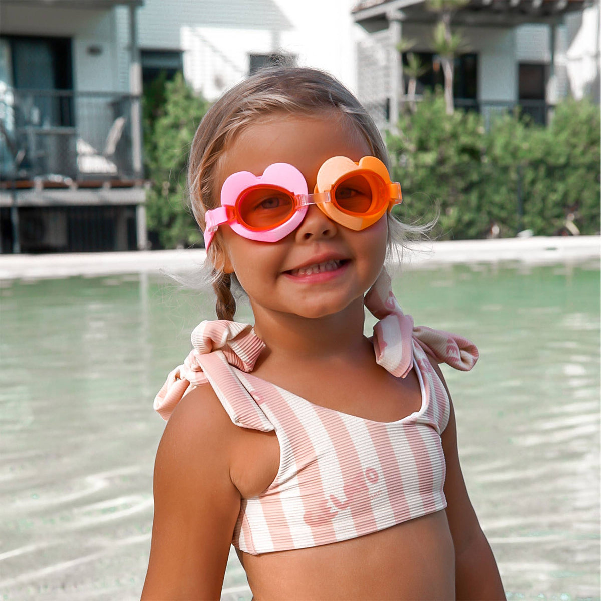 Sunnylife Poppy the Peach swimming goggles with colorful, playful design for kids, featuring adjustable straps and clear lenses.