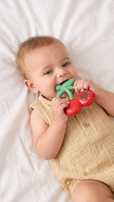 Itzy Ritzy Bitzy Shake silicone teether with cherry design and attached rattle for babies to chew and play.