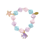 Tiny Treats and ZOMI GEMS Mermaid Seashell Bracelet Tower featuring colorful seashells and ocean-inspired jewelry display.