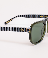 SARDINE Stevie Olive Regatta flip-flops with green and black straps, showcasing their comfortable design and stylish look.