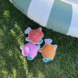 Set of three Sunnylife Dive Buddies Poppy the Peach inflatable pool toys in vibrant peach color with playful design.