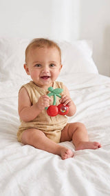 Itzy Ritzy Bitzy Shake silicone teether with cherry design and attached rattle for babies to chew and play.