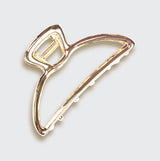 Gold open shape claw clip by KITSCH, stylish hair accessory with a modern open design, perfect for securing hair.