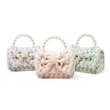 Girls pink tweed handbag with a large pearl bow detail, stylish and cute for everyday or special occasions.