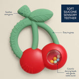 Itzy Ritzy Bitzy Shake silicone teether with rattle featuring cherry design, soft silicone material, and vibrant red color for babies.