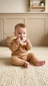 Itzy Ritzy Bitzy Shake silicone teether with cherry design and attached rattle for soothing and entertainment for babies.