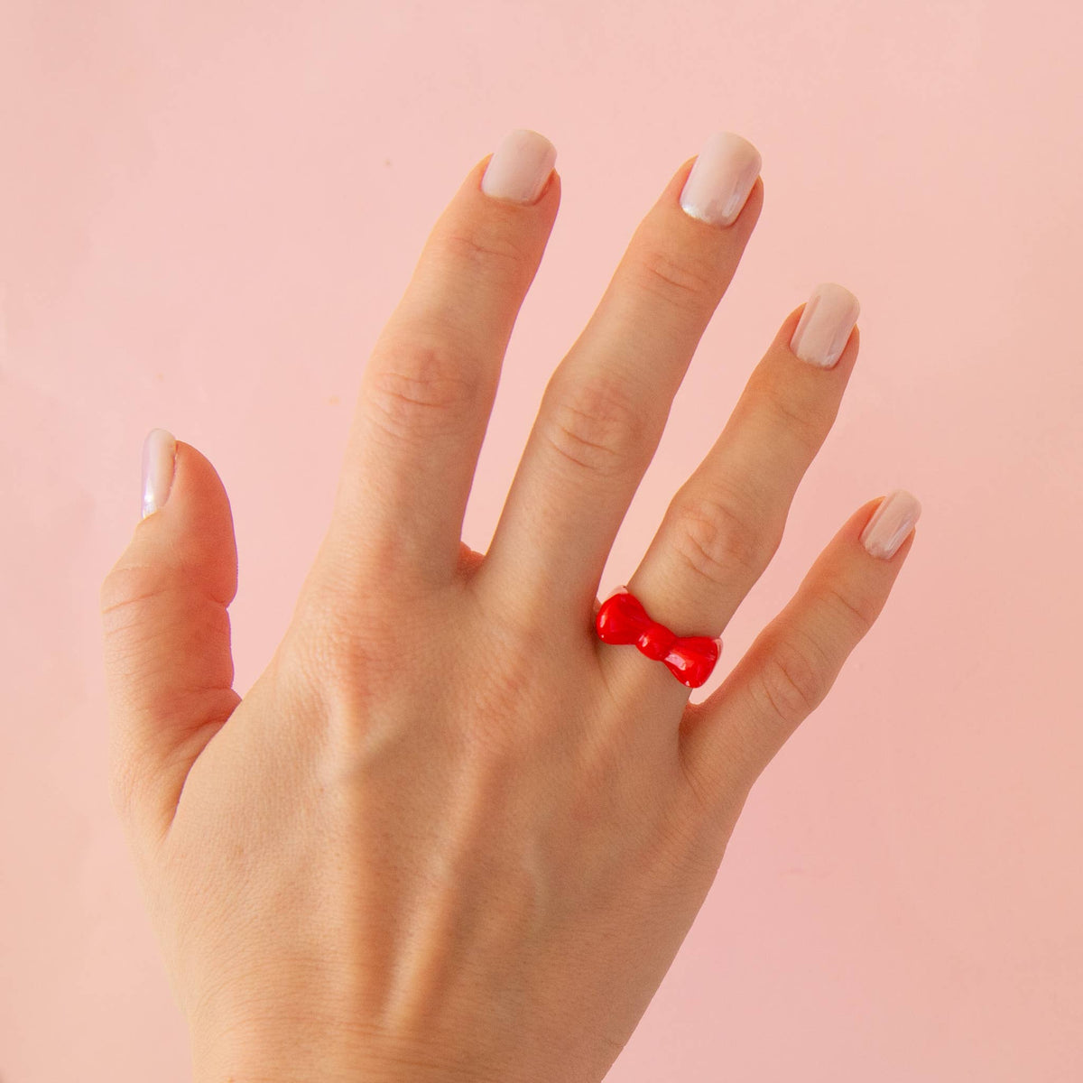 Red Kitsch Bow Ring by Sunshine Studios, featuring a stylish bow design in bright red, size 6, on a neutral background.