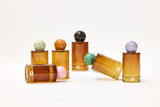 Choice Blooms Room Linen Fragrance Spray with Amber, Rose, and Oud in elegant bottle, designed to freshen linens and add a luxurious scent.
