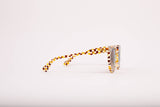 SARDINE Aster Toasted Moxie Round Checkered Sunglasses with brown and beige checkered frames and tinted lenses.