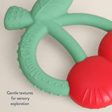 Itzy Ritzy Bitzy Shake silicone teether with cherry design and rattle, perfect for soothing babies and teething relief.