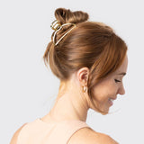 Gold open shape claw clip by KITSCH, showcasing a stylish, minimalist hair accessory with smooth, curved design.