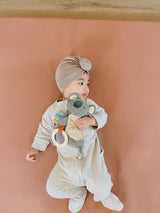 Itzy Ritzy Bitzy Crinkle™ Sensory Toy with Teether in dinosaur design, soft fabric with crinkle textures and teething features.