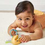 Itzy Ritzy Itzy Treat Fortune Cookie Teether in soft fabric with embroidered details, designed for babies' teething relief.