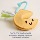 Itzy Ritzy Itzy Treat Fortune Cookie Teether in soft fabric with plush and textured details for soothing gums.