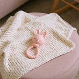 Pink Bunny Sweetie Rattle by Itzy Ritzy, soft plush toy with a cute bunny design and gentle rattling sound for babies.