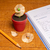 Flower pot-shaped pencil sharpener by Kikkerland Design Inc, featuring a colorful, decorative design for desk or classroom use.
