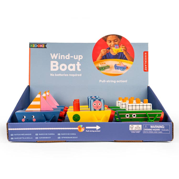 Kikkerland Design Inc wind-up toy boat with colorful plastic hull and miniature details, ready to float in water or display.