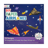 Set of 24 DIY paper airplane designs from OOLY activity kit, featuring colorful paper and folding instructions.