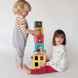 Colorful Peek-A-Boo House stacking blocks play set by Petit Collage with various shaped blocks for creative play.