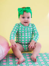 Baby girl pink coastal cane long sleeve rash guard swimsuit with signature rear ruffles, from RuffleButts + RuggedButts, for infants.
