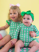 Baby girls pink coastal cane long sleeve rash guard swimsuit with signature rear ruffles, designed by RuffleButts + RuggedButts.