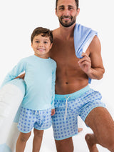 Boys periwinkle blue coastal cane performance hybrid dolphin hem swim trunks by RuffleButts and RuggedButts, suitable for ages 18-24 months