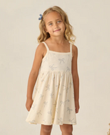Rylee & Cru Lea Dress for toddler with sailor bows, white with colorful floral pattern, featuring ruffled sleeves and bow details.