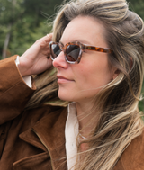 SARDINE Demi Bella Vista sunglasses with stylish frame and tinted lenses, sunglasses resting on a white surface.