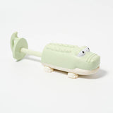 Pastel green crocodile-shaped water squirters by Sunnylife, featuring a playful design perfect for summer water play.