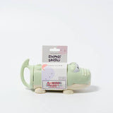 Pastel green crocodile-shaped water squirter by Sunnylife, featuring a playful design for outdoor water play.