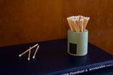 Black and rainbow-colored cylinder match holder by Tenn Prairie, featuring a sleek design for storing matches.