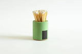Black and rainbow-colored cylinder match holder by Tenn Prairie, designed for storing matches in a sleek, modern container.