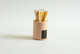 Black and rainbow-colored cylinder match holder by Tenn Prairie with a sleek, modern design for safe and stylish match storage.
