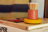 Black and rainbow cylinder match holder by Tenn Prairie with a sleek, modern design for safe and stylish match storage.