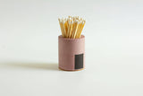Black and rainbow Tenn Prairie cylinder match holder with a sleek design and vibrant color accents.