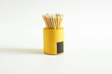 Black and rainbow cylinder match holder by Tenn Prairie with a sleek, minimalist design for safe and stylish match storage.