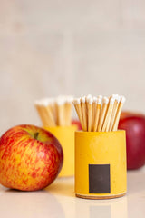 Black and rainbow cylinder match holder by Tenn Prairie with a sleek, modern design and a secure lid for storing matches.