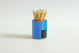 Black and rainbow cylindrical match holder by Tenn Prairie with a sleek, modern design for safe and stylish match storage.