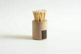 Black and rainbow-colored cylinder match holder by Tenn Prairie, featuring a sleek modern design with a secure lid.