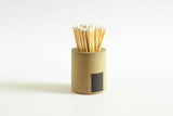 Black and rainbow-colored cylinder match holder by Tenn Prairie, featuring a sleek design for storing matches.