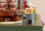 Black and rainbow-colored Tenn Prairie cylinder match holder with a modern design for safe, stylish match storage