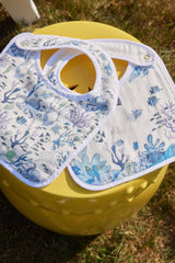 Colorful Coral Reef Bib by Timo & Violet featuring vibrant marine-inspired patterns on soft fabric for babies.