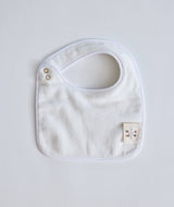 Colorful Coral Reef Bib by Timo & Violet featuring vibrant marine-inspired patterns on soft fabric for babies.